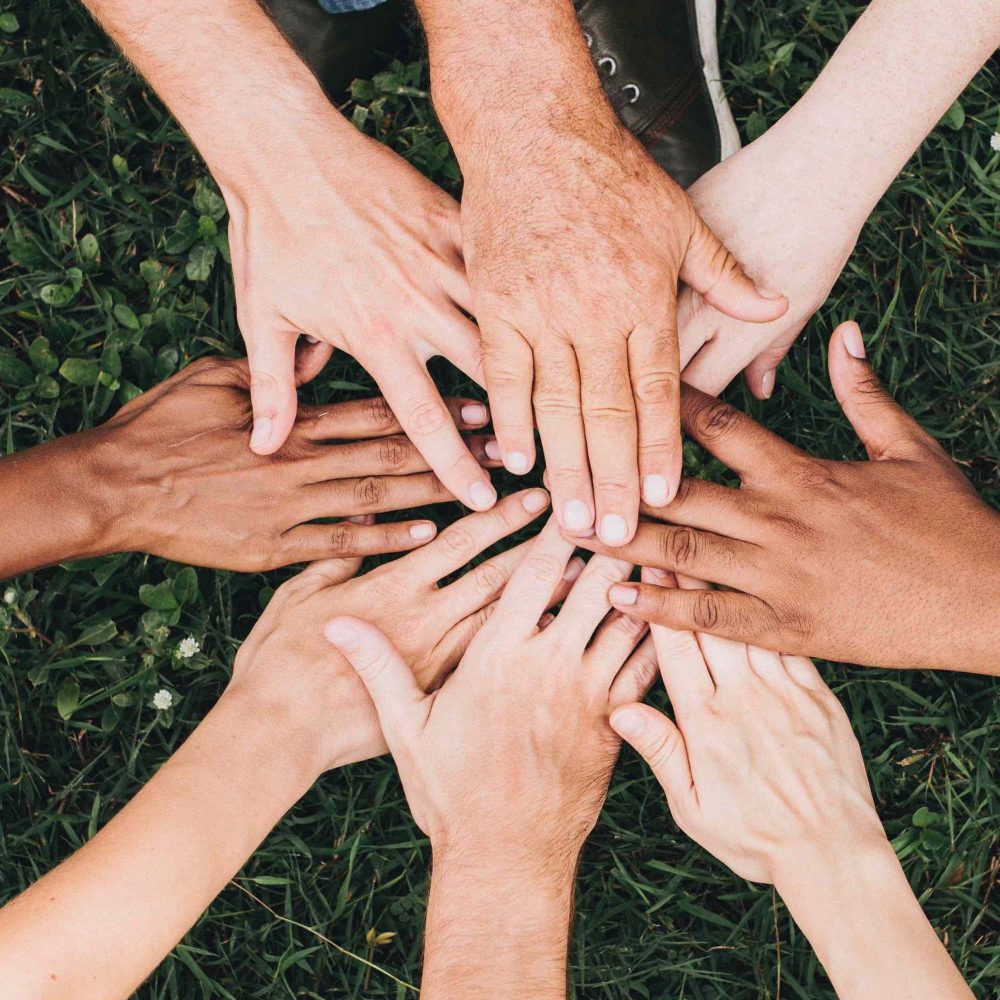 circle of hands touching at center