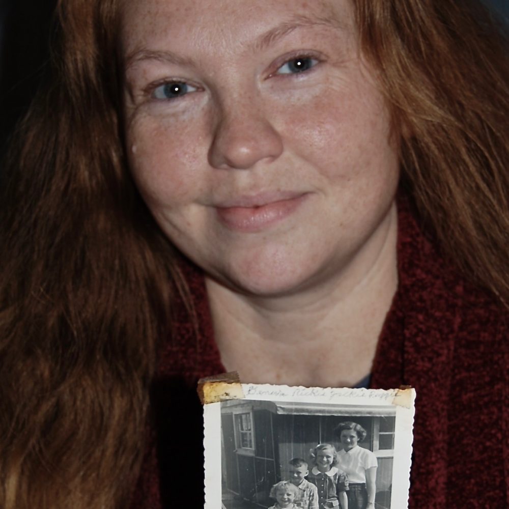 Leanda holding a picture of her grandma