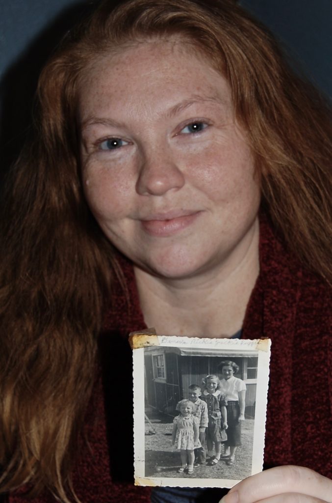 Leanda holding a picture of her grandma